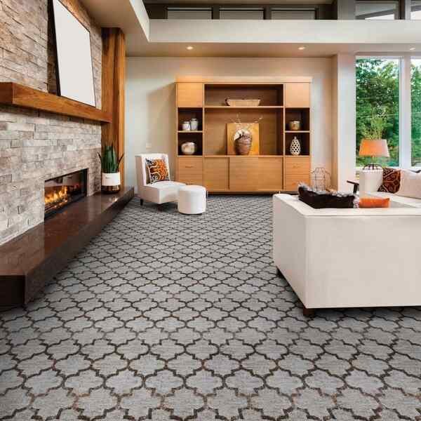 Elegant living room with a large patterned carpet featuring a gray and taupe Moroccan trellis design, ideal for luxury villa and apartment interior design in Dubai