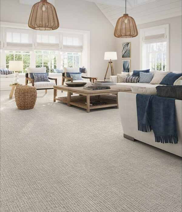 Light gray patterned loop carpet installed in a bright, modern coastal-style living room, suitable for comfortable luxury interior design in Dubai homes