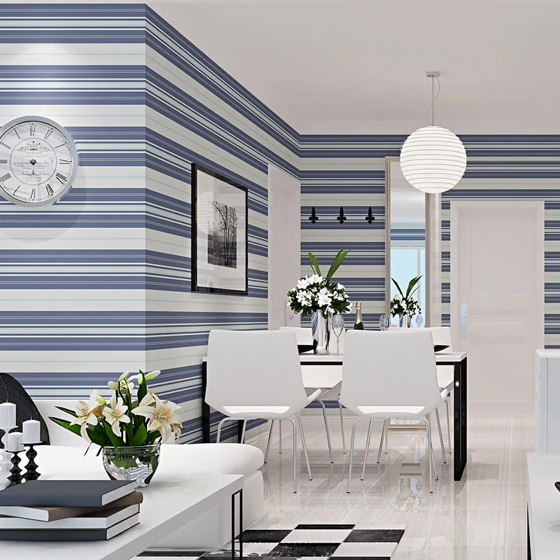 Modern living room and dining area featuring horizontal striped wallpaper in shades of blue and white, ideal for stylish accent walls and contemporary interior design in Dubai homes and commercial spaces